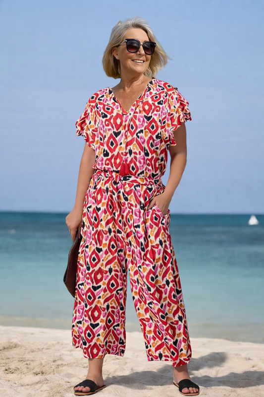 Lebendiger bedruckter Jumpsuit mit V-Ausschnitt von Andrea Serena